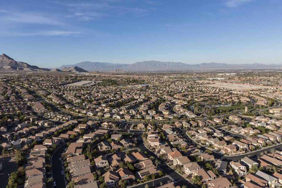 Aerial view of an established Centennial Hills neighborhood, with mature homes, tree-lined streets and the Spring Mountains in the background.